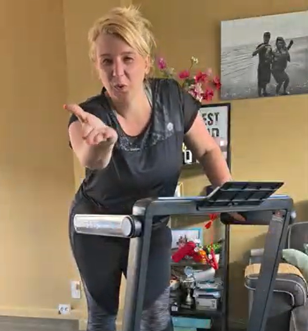 Nadine takes steps on a compact treadmill in her living room, while her kids play happily